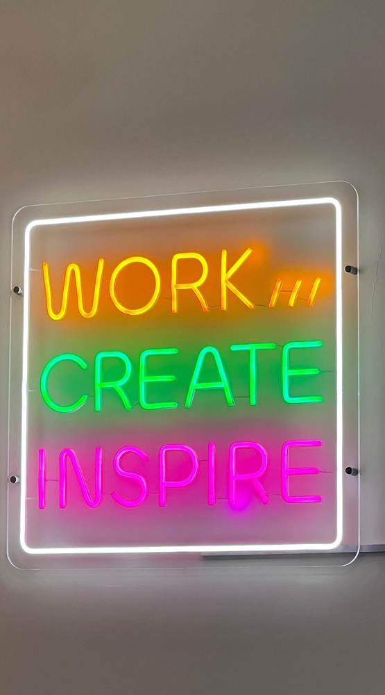 Neon sign reading Work, Create, Inspire